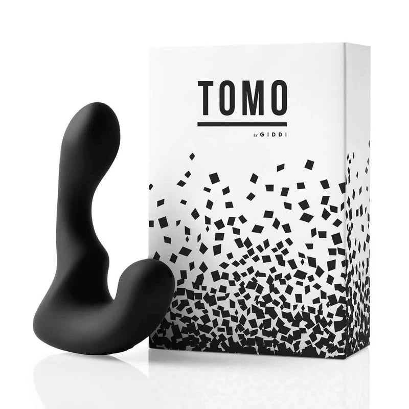 Black butt plug next to a white box with 'TOMO' branding on a white background