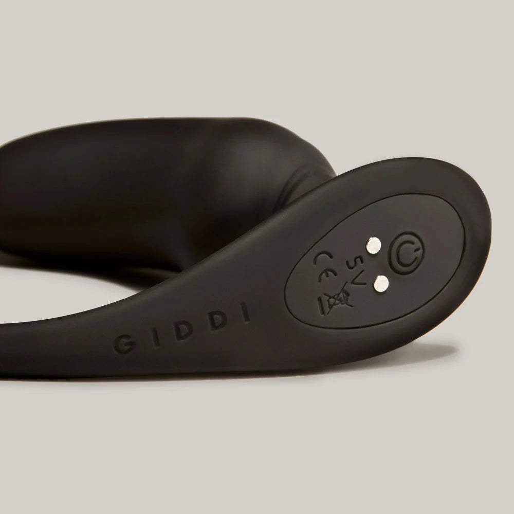 Vulcan vibrating prostate plug close up of control panel showing power button and magnetic charging port