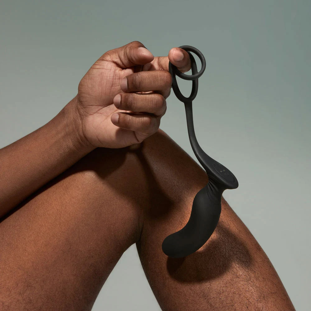 Vulcan vibrating prostate plug hanging from model finger