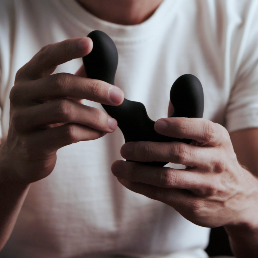 Close up image of a man holding a Giddi prostate massager