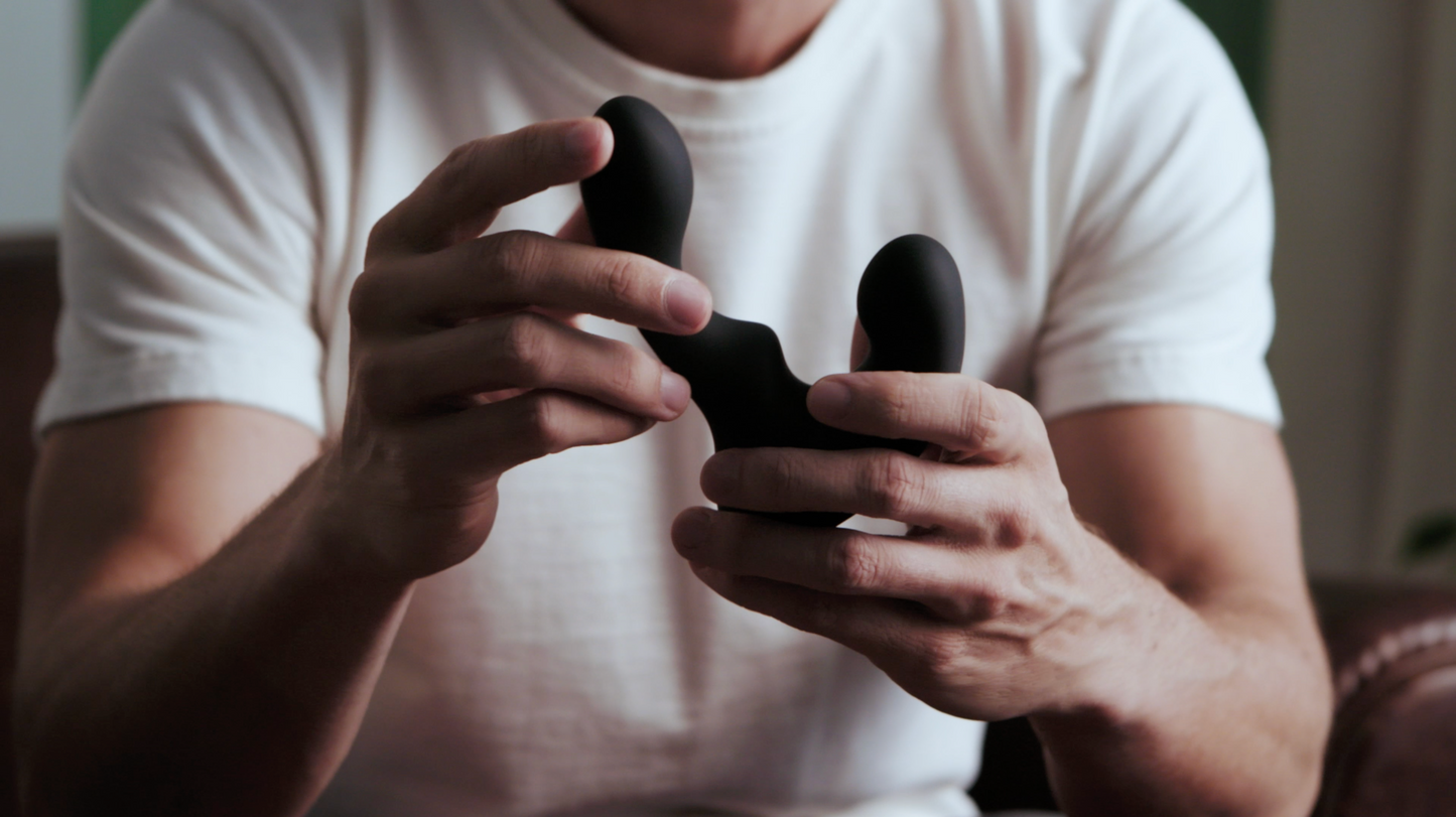 Close up image of a man holding a Giddi prostate massager