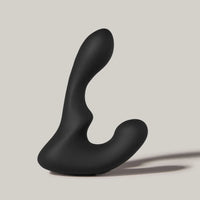 Black silicone butt plug on a beige background