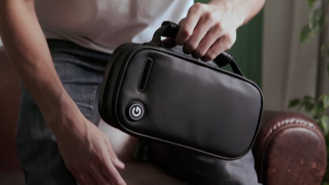 video thumbnail for giddi uv sterilizer bag, shows bag hand held by handle with video play button in center